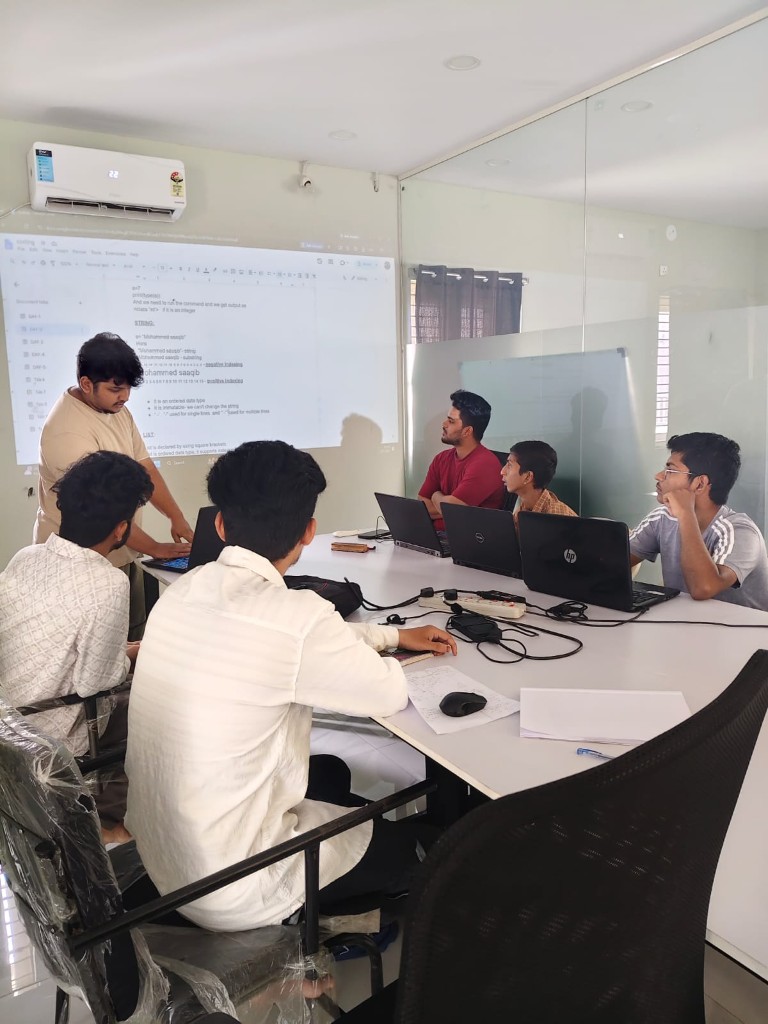 Internship coding workshop with Python concepts projected on screen